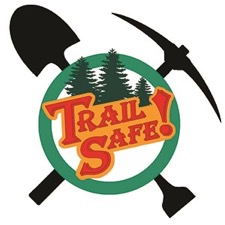 Pick and shovel crossed in front of trees make up a logo for the trail safety program